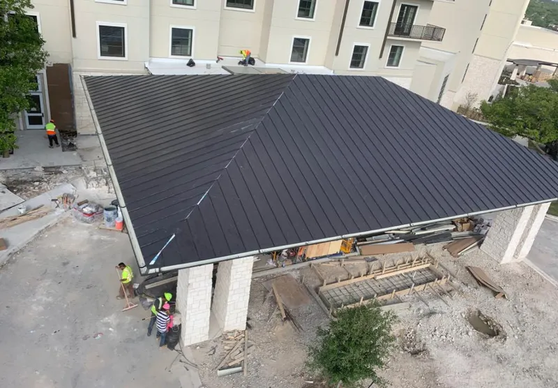 Metal roofing installation team working on a commercial building in Palm Springs